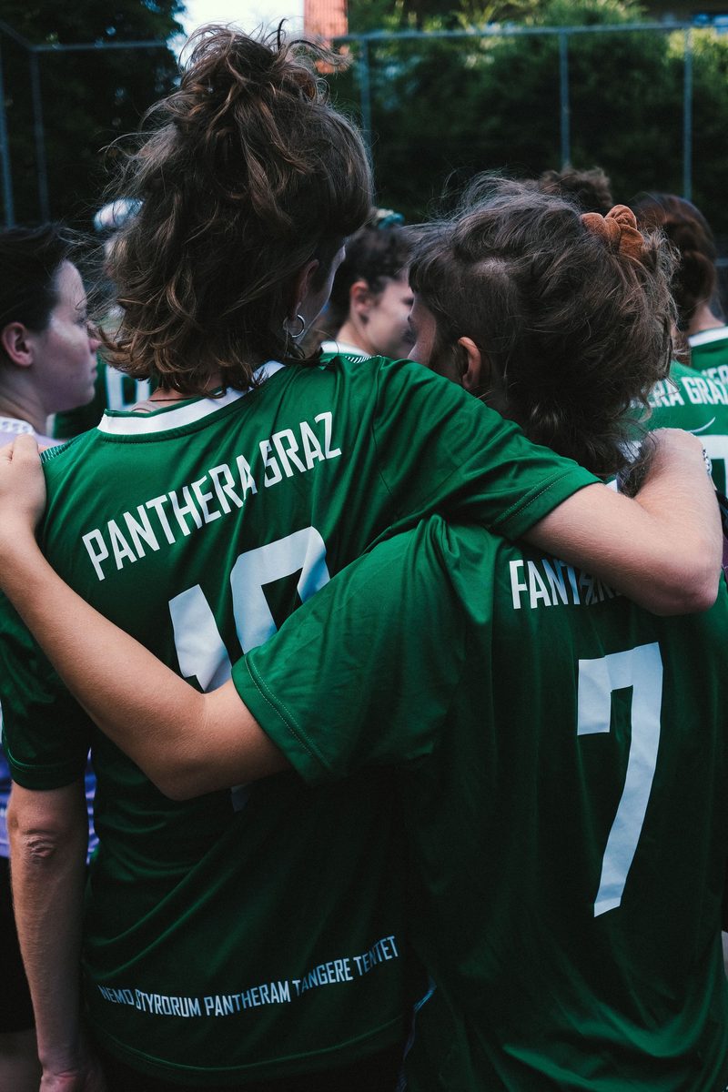 Team players in green jerseys standing together